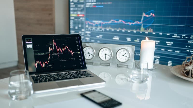 A modern workspace featuring financial charts and multiple clocks on a white table, ideal for trading., tags: attribution windows casino affiliate - pexel