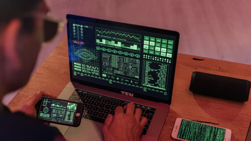 Man working with cybersecurity software on laptop and smartphone., tags: antidetect browsers casino affiliate - pexel